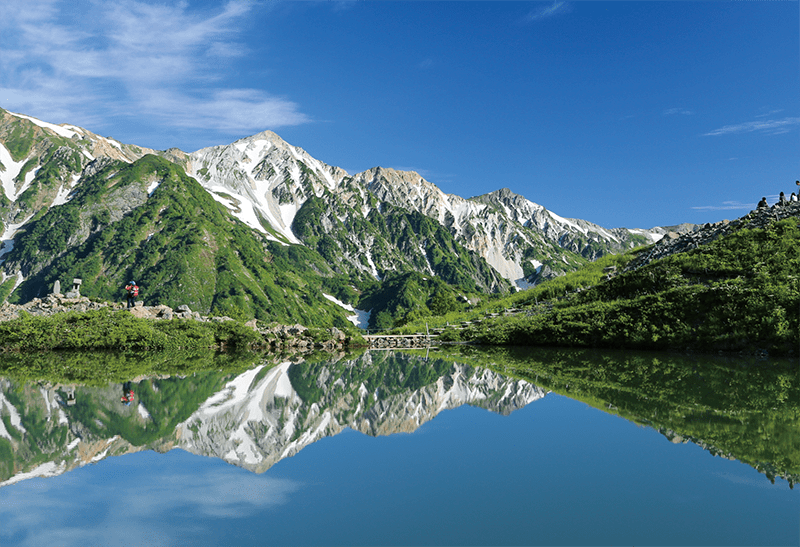 Happo Pond reflecting Hakuba’s mountains under a blue sky